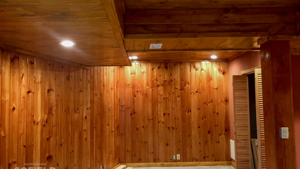 Wood accents throughout the home with wood flooring and wood paneling.